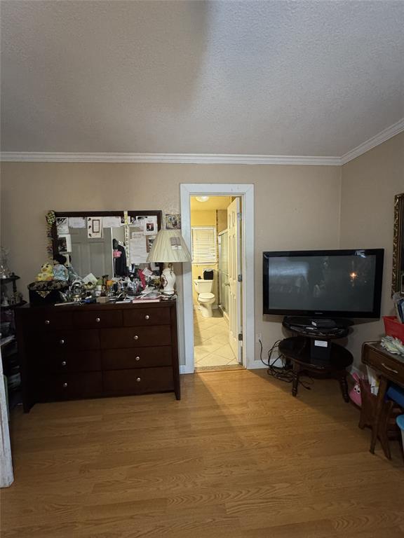 636 East Kempner Street Mabank, TX 75147 - Photo 25 of 28 Wood-finish flooring throughout, complemented by crown molding and neutral wall tones