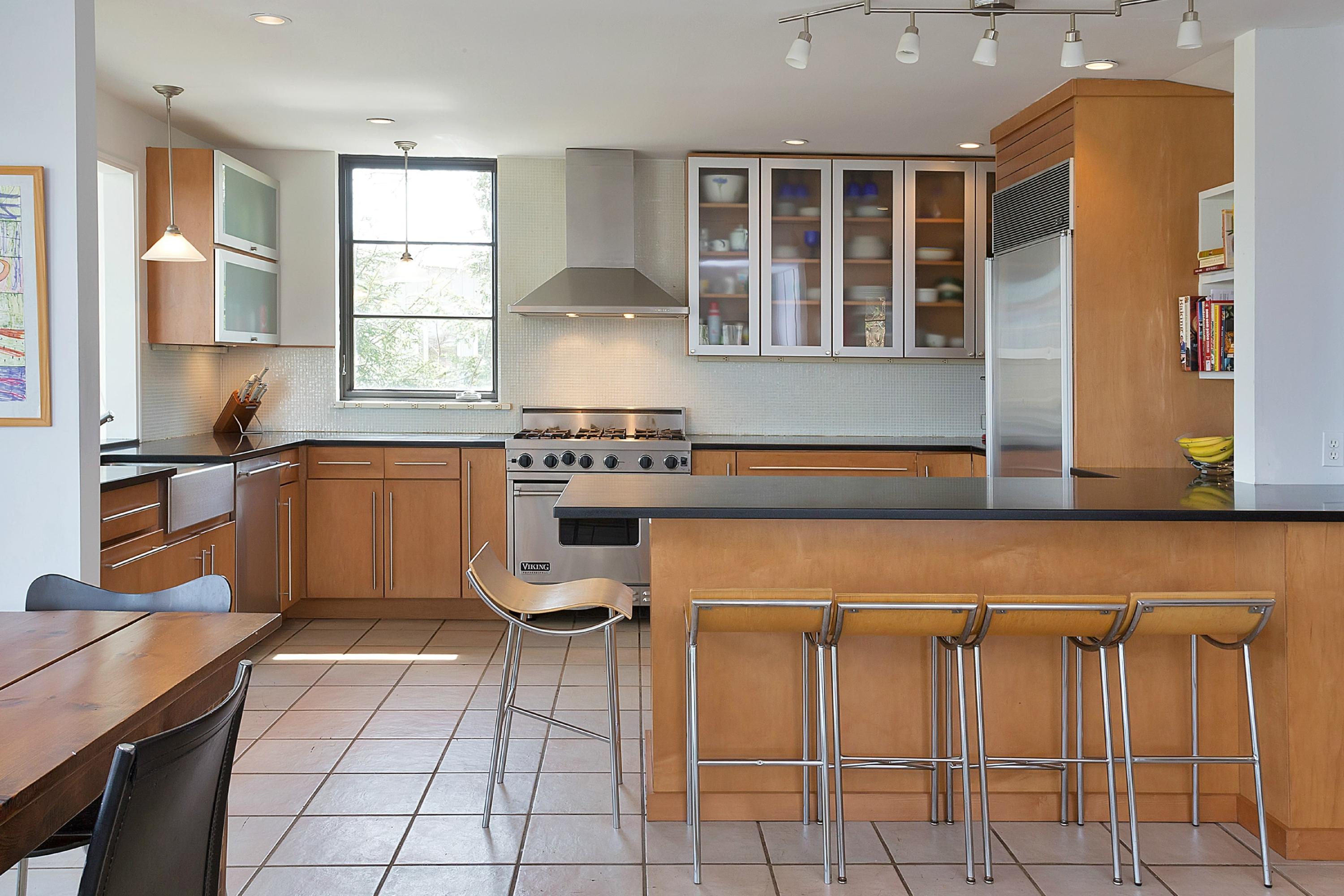 28 Dock Road Norwalk, CT 06854 - Photo 9 of 24 a kitchen with stainless steel appliances granite countertop a stove a sink and a microwave