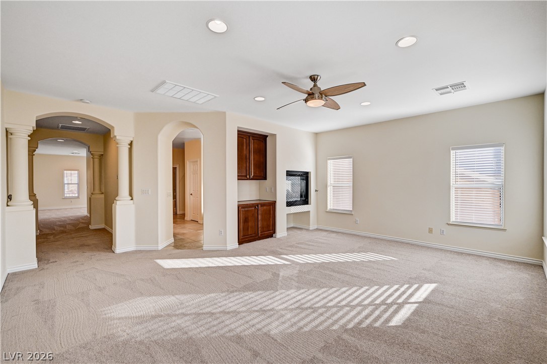 6761 Clay TABLET Street Las Vegas, NV 89149 - Photo 36 of 73 Arched entryways and soft neutral carpeting define this comfortable gathering space.