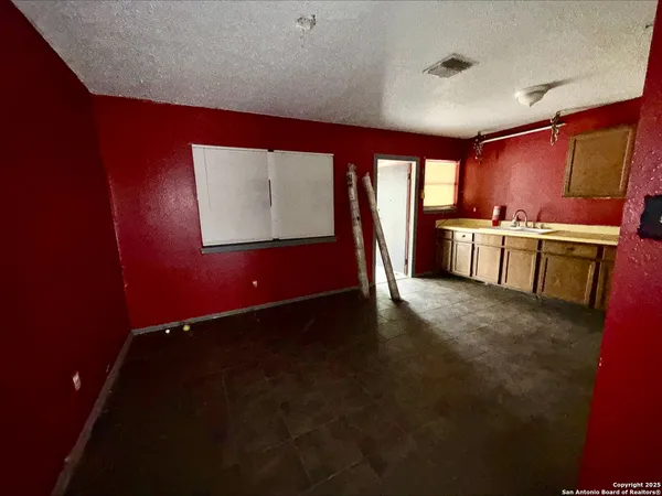 a kitchen with a refrigerator and a stove top oven