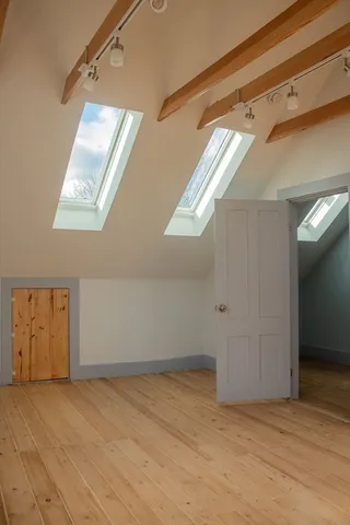 a view of an entryway with wooden floor