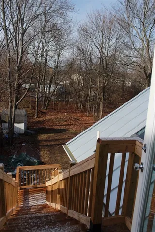 a view of a yard with wooden fence