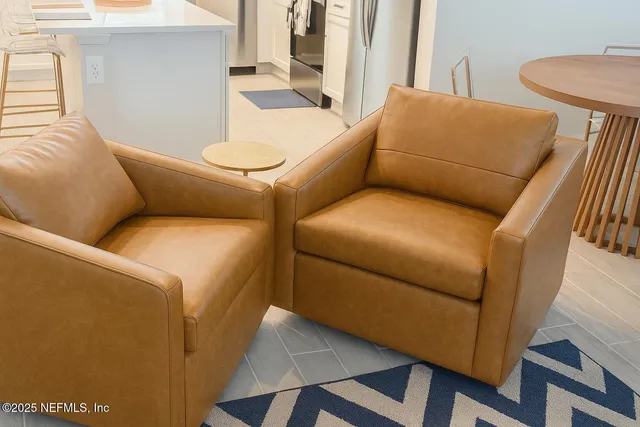 a view of a workspace with furniture and a potted plant