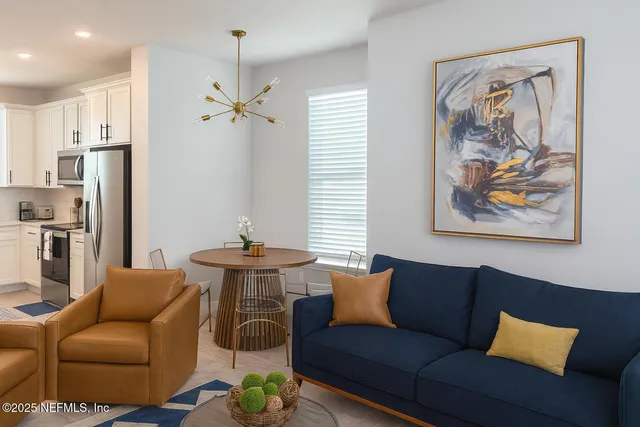 a bedroom with a bed a flat screen tv and a couch