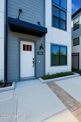 a living room with furniture a fireplace and a chandelier
