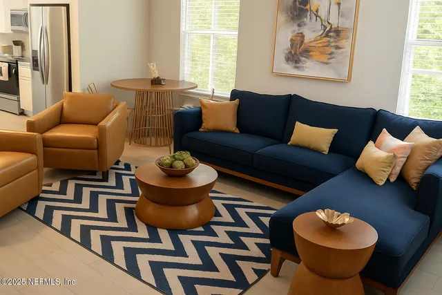 a living room with furniture a chandelier and a painting