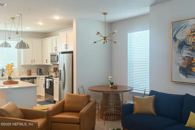 a bedroom with a bed and two window