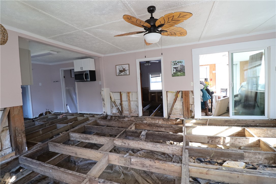200 Laurel And Hardy Lake Road Marietta, SC 29661 - Photo 23 of 47 Unfinished interior space ready for renovation features exposed floor joists and a ceiling fan.