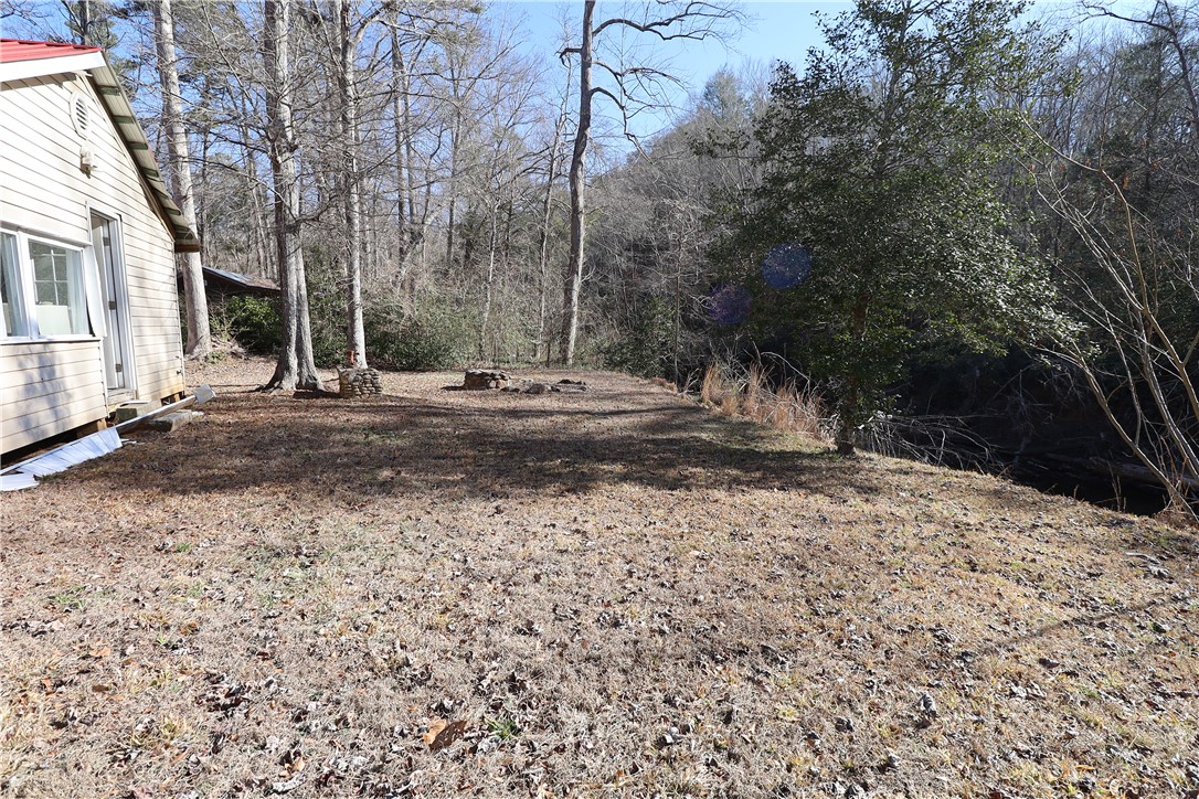 200 Laurel And Hardy Lake Road Marietta, SC 29661 - Photo 40 of 47 This tranquil yard offers a natural setting with ample space for outdoor enjoyment.