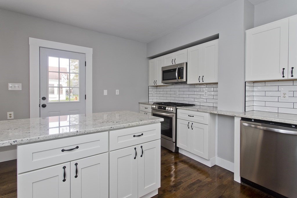 85 Chapel Street Warren, MA 01092 - Photo 21 of 42 a kitchen with granite countertop white cabinets and white appliances