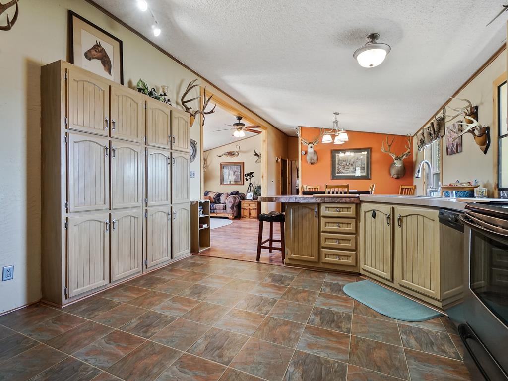 4805 Cedar Road Delta, CO 81416 - Photo 23 of 36 a large kitchen with stainless steel appliances a stove a refrigerator and cabinets