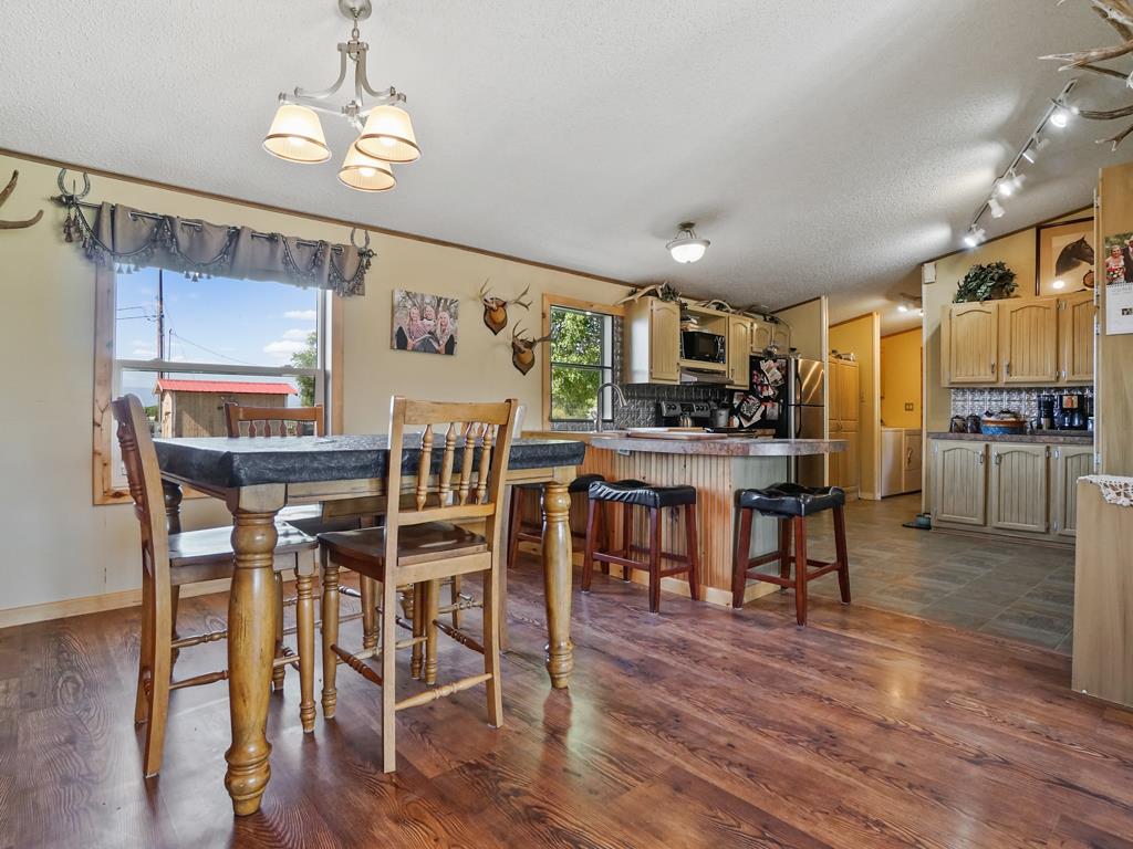 4805 Cedar Road Delta, CO 81416 - Photo 27 of 36 a view of a dining room with furniture and wooden floor