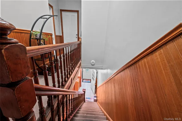 a view of a hallway with wooden floor and stairs