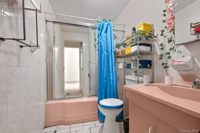 a view of storage and utility room with two washing machine