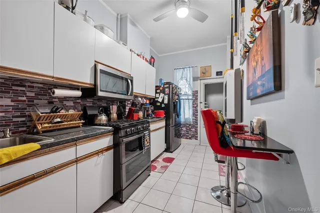 a kitchen with stainless steel appliances kitchen island granite countertop a sink and cabinets