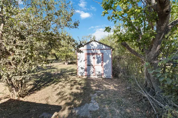 a view of a house with a tree and yard