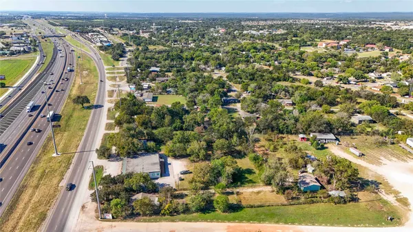 an aerial view of residential houses with outdoor space and street view