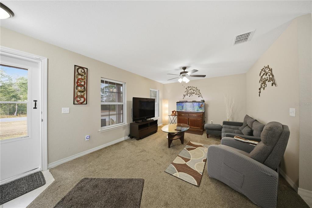 157 Spruce Road Ocala, FL 34472 - Photo 4 of 19 a living room with furniture and a flat screen tv