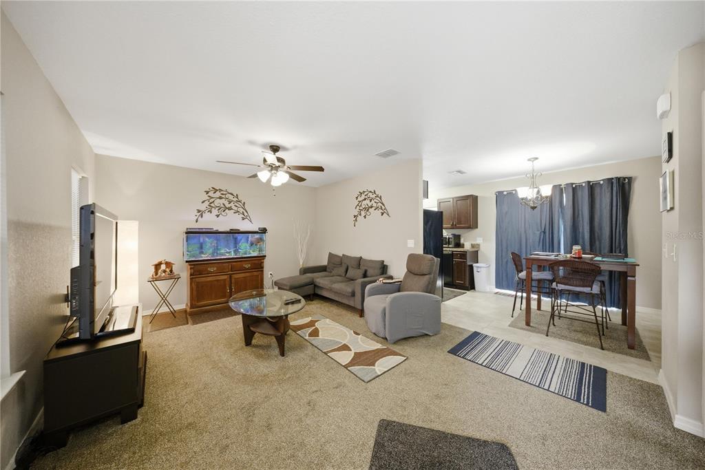 157 Spruce Road Ocala, FL 34472 - Photo 5 of 19 a living room with furniture a fireplace and a flat screen tv