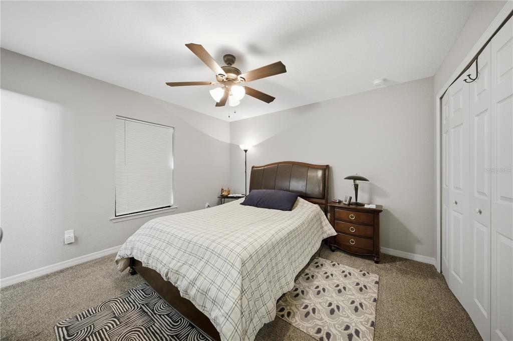 157 Spruce Road Ocala, FL 34472 - Photo 9 of 19 a bedroom with a bed and a chandelier