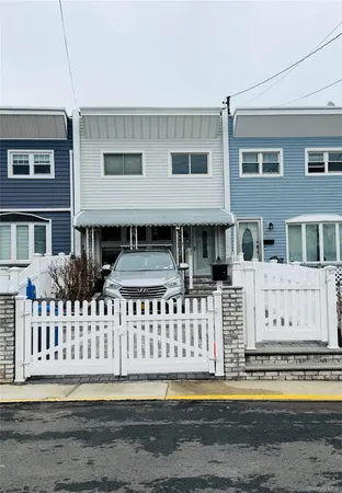 a front view of a house with a fence