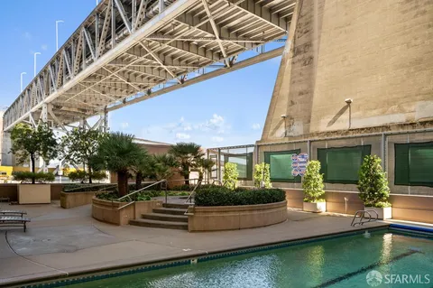 a view of a house with swimming pool and sitting area