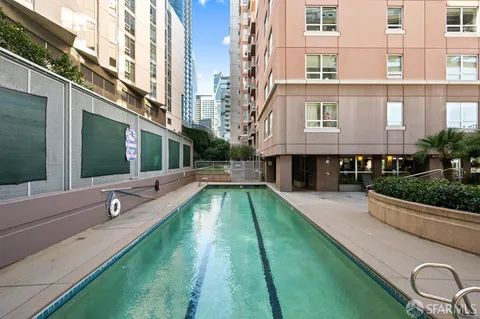 a swimming pool with outdoor seating and yard