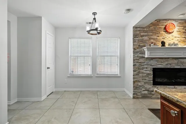 a view of an empty room with a fireplace and a window