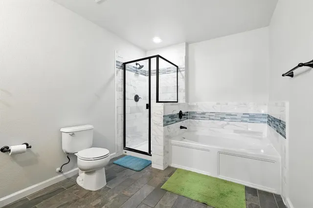 a bathroom with a toilet a sink and a shower