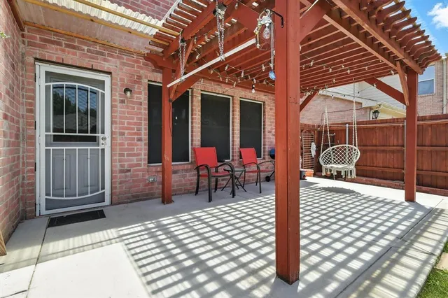 a view of a patio with a table and chairs