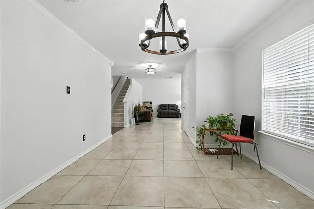 a hallway with a chandelier and living room