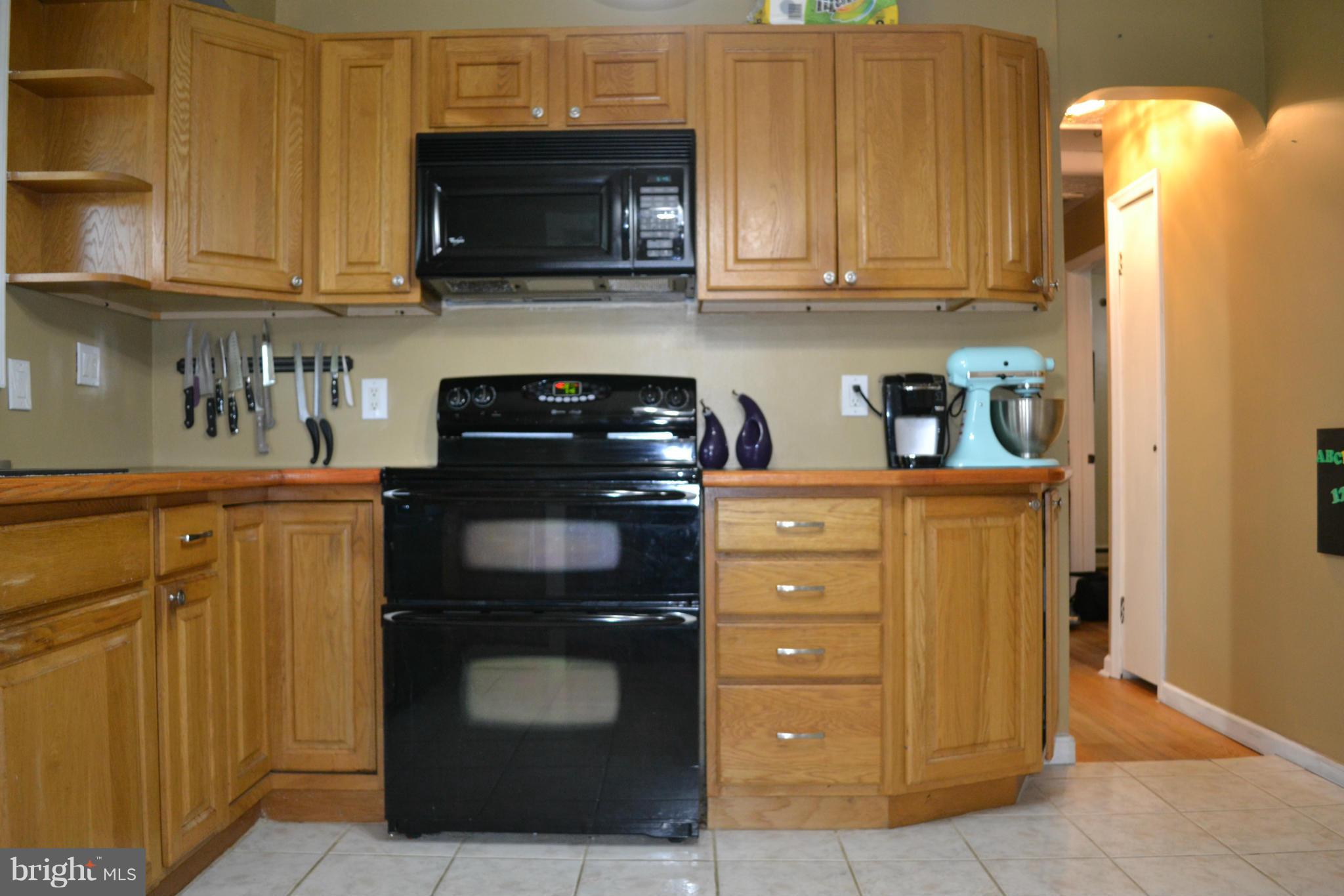 1211 Meadow View Road Pasadena, MD 21122 - Photo 12 of 20 a kitchen with a stove and a microwave