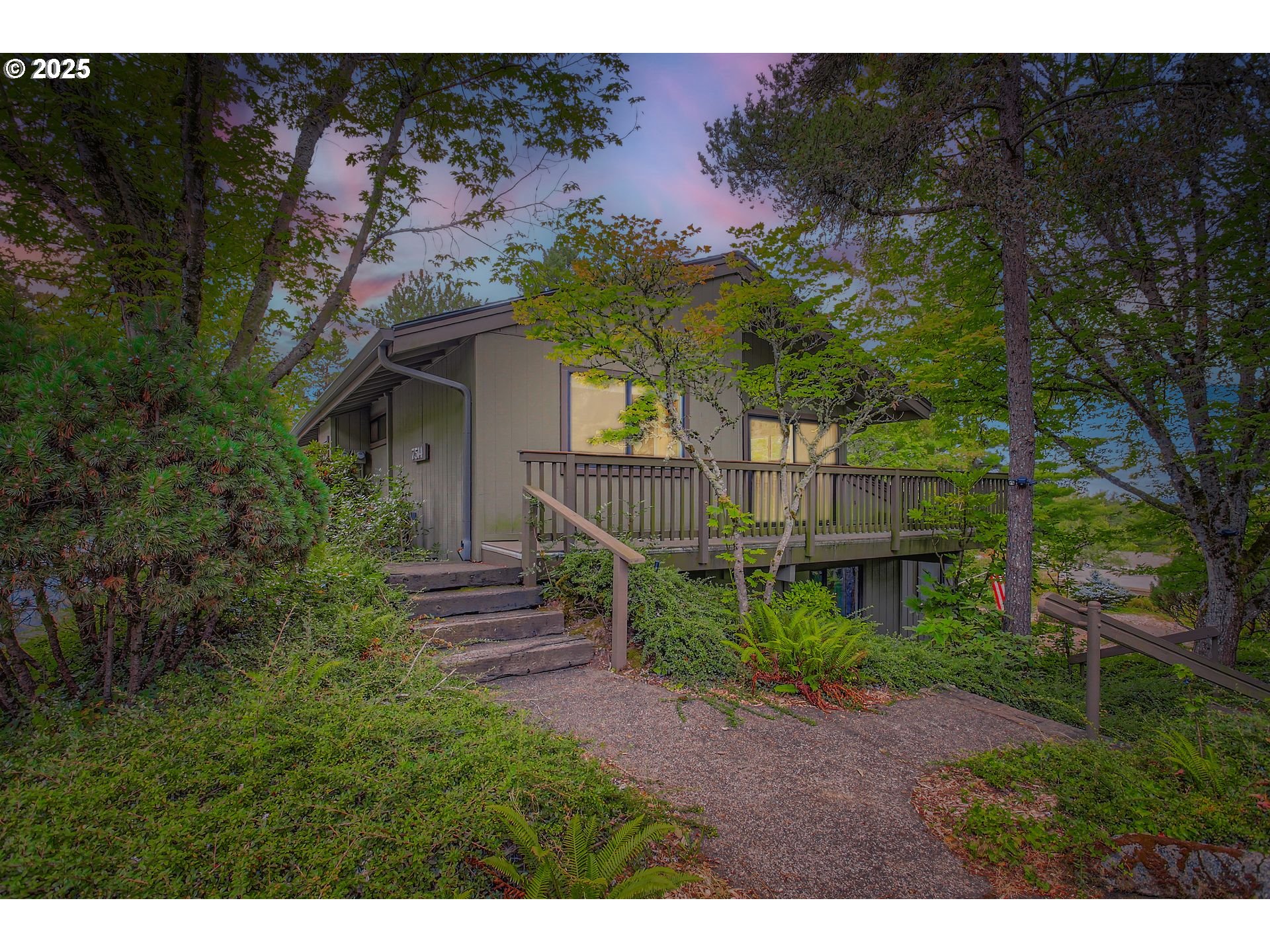 a view of a house with a small yard and floor to ceiling window
