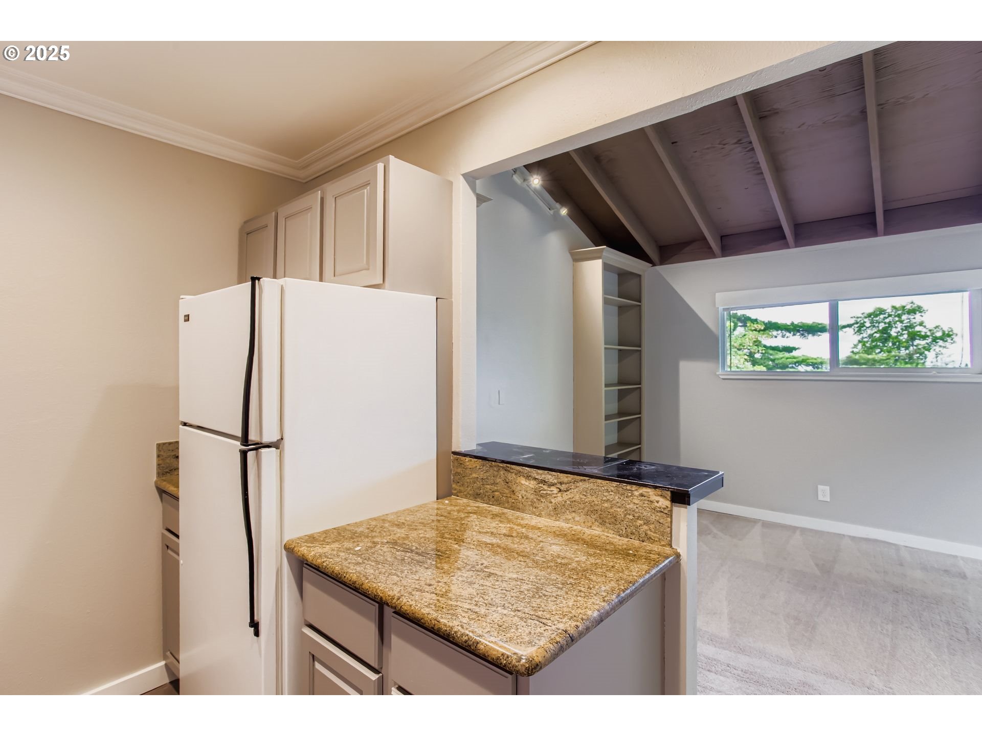 7514 Southwest Barnes Road, Unit A Portland, OR 97225 - Photo 11 of 24 a kitchen with a refrigerator and countertop