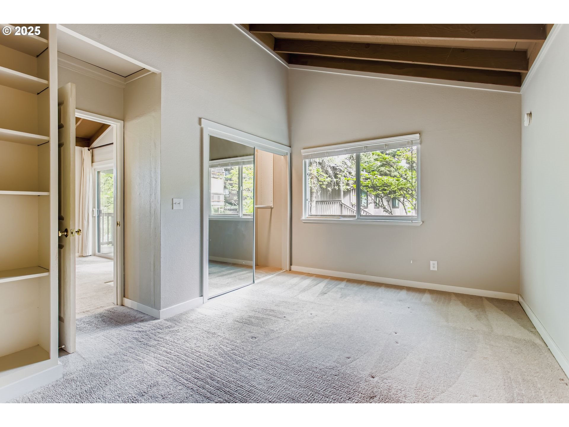 7514 Southwest Barnes Road, Unit A Portland, OR 97225 - Photo 13 of 24 a view of an empty room with a window