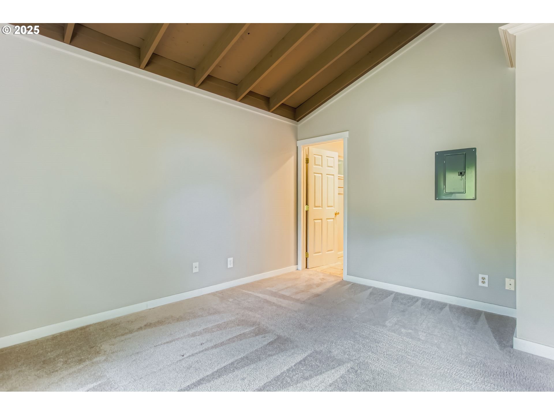 7514 Southwest Barnes Road, Unit A Portland, OR 97225 - Photo 15 of 24 a view of an empty room with wooden floor