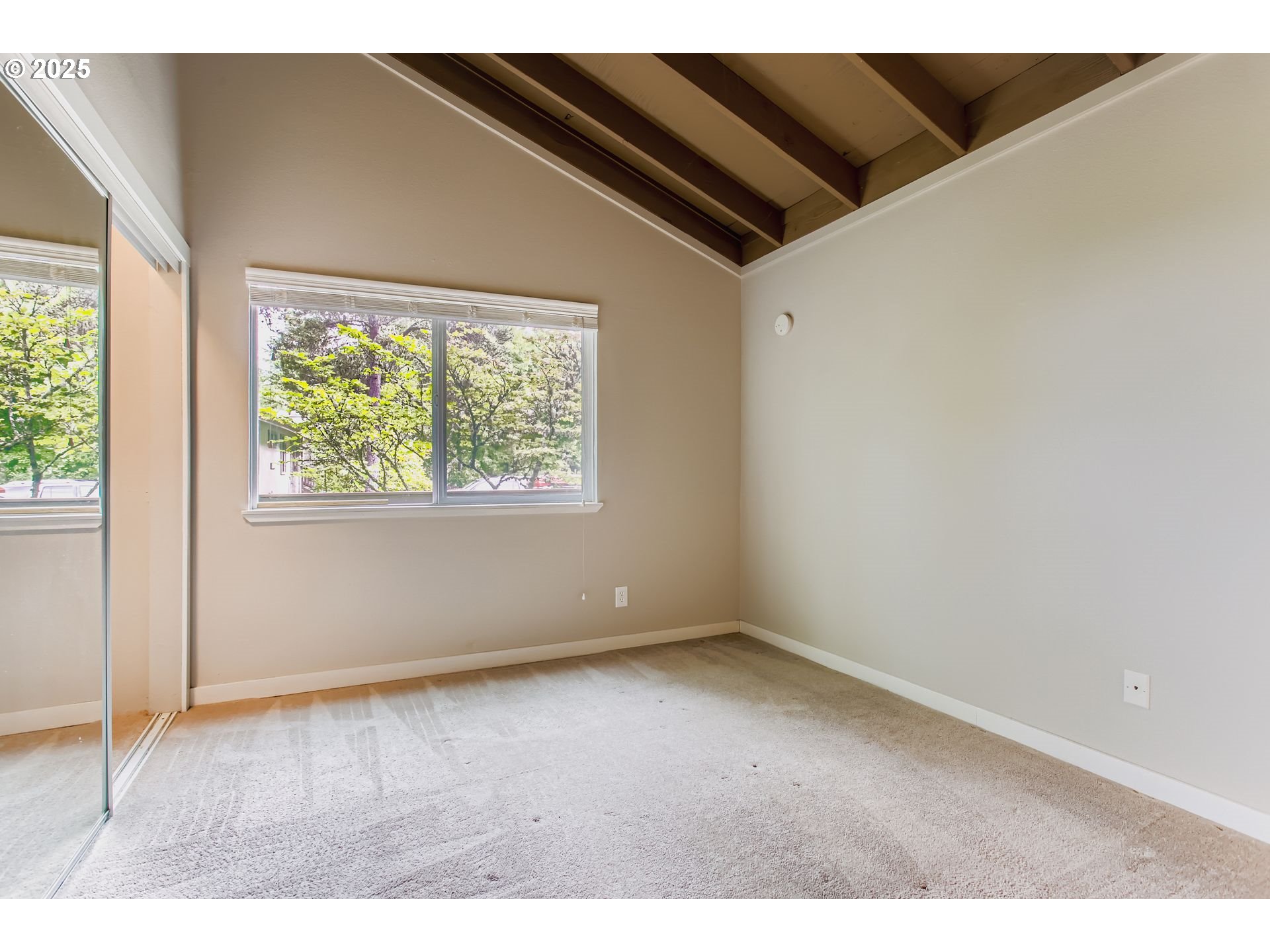 7514 Southwest Barnes Road, Unit A Portland, OR 97225 - Photo 16 of 24 a view of an empty room with a window