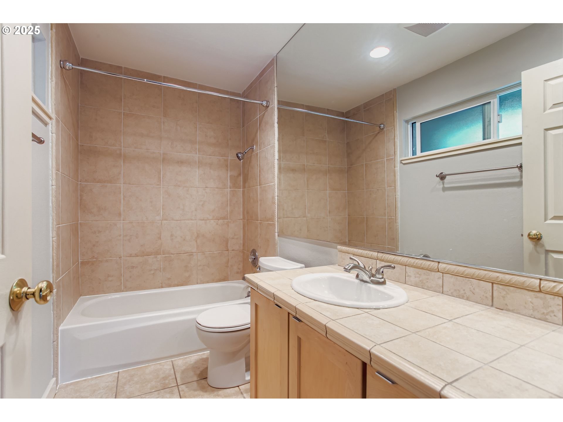 7514 Southwest Barnes Road, Unit A Portland, OR 97225 - Photo 17 of 24 a bathroom with a granite countertop sink a toilet and shower