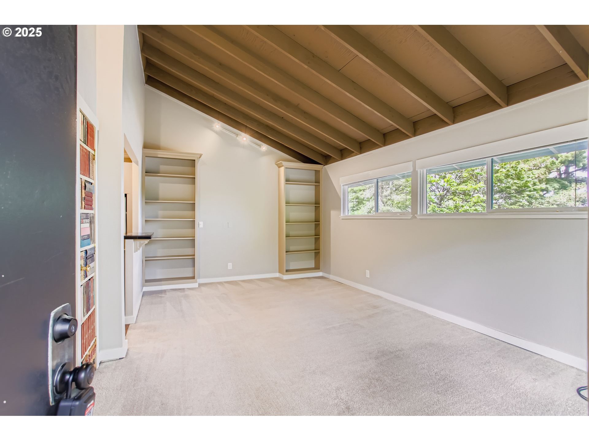 7514 Southwest Barnes Road, Unit A Portland, OR 97225 - Photo 2 of 24 a view of an empty room with a window