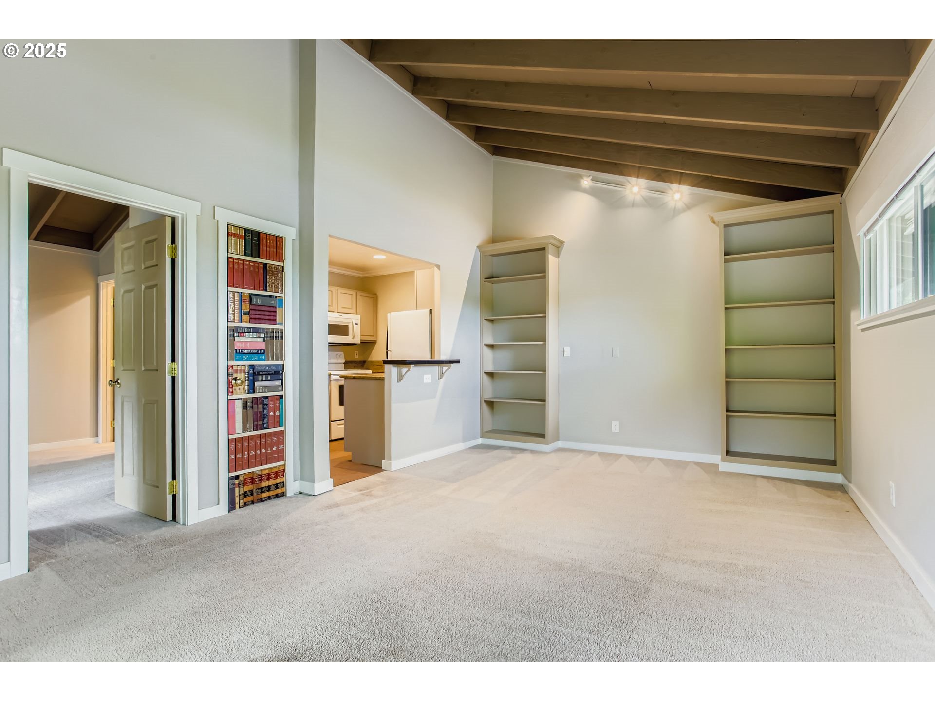 7514 Southwest Barnes Road, Unit A Portland, OR 97225 - Photo 3 of 24 a view of empty room with refrigerator and cabinet