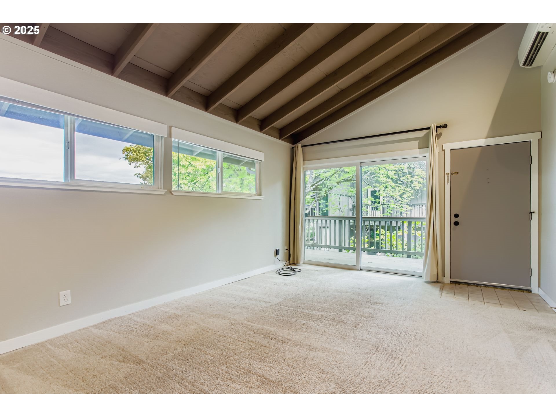 7514 Southwest Barnes Road, Unit A Portland, OR 97225 - Photo 5 of 24 a view of an empty room with a window