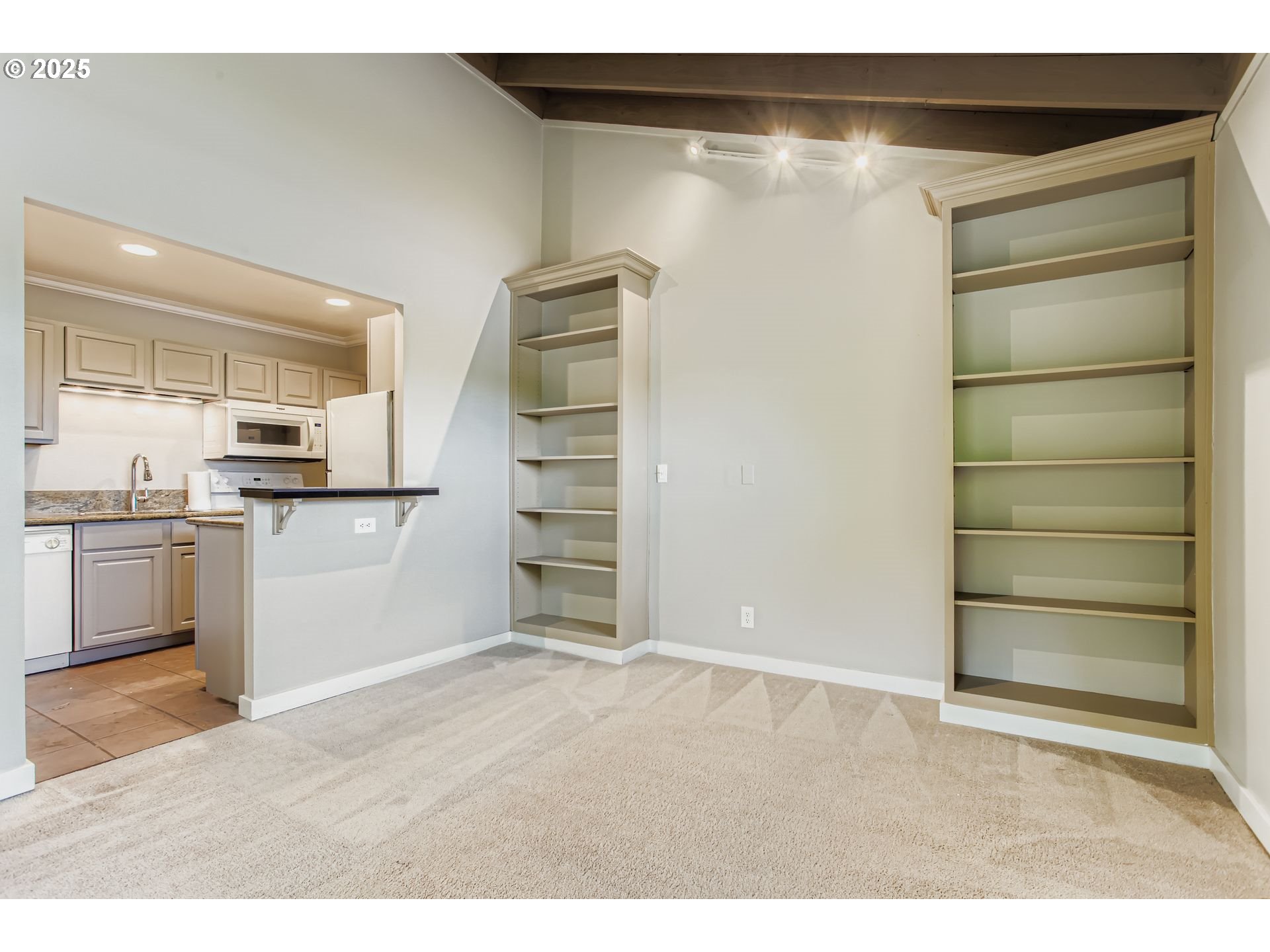 7514 Southwest Barnes Road, Unit A Portland, OR 97225 - Photo 6 of 24 a view of kitchen with cabinets and wooden floor