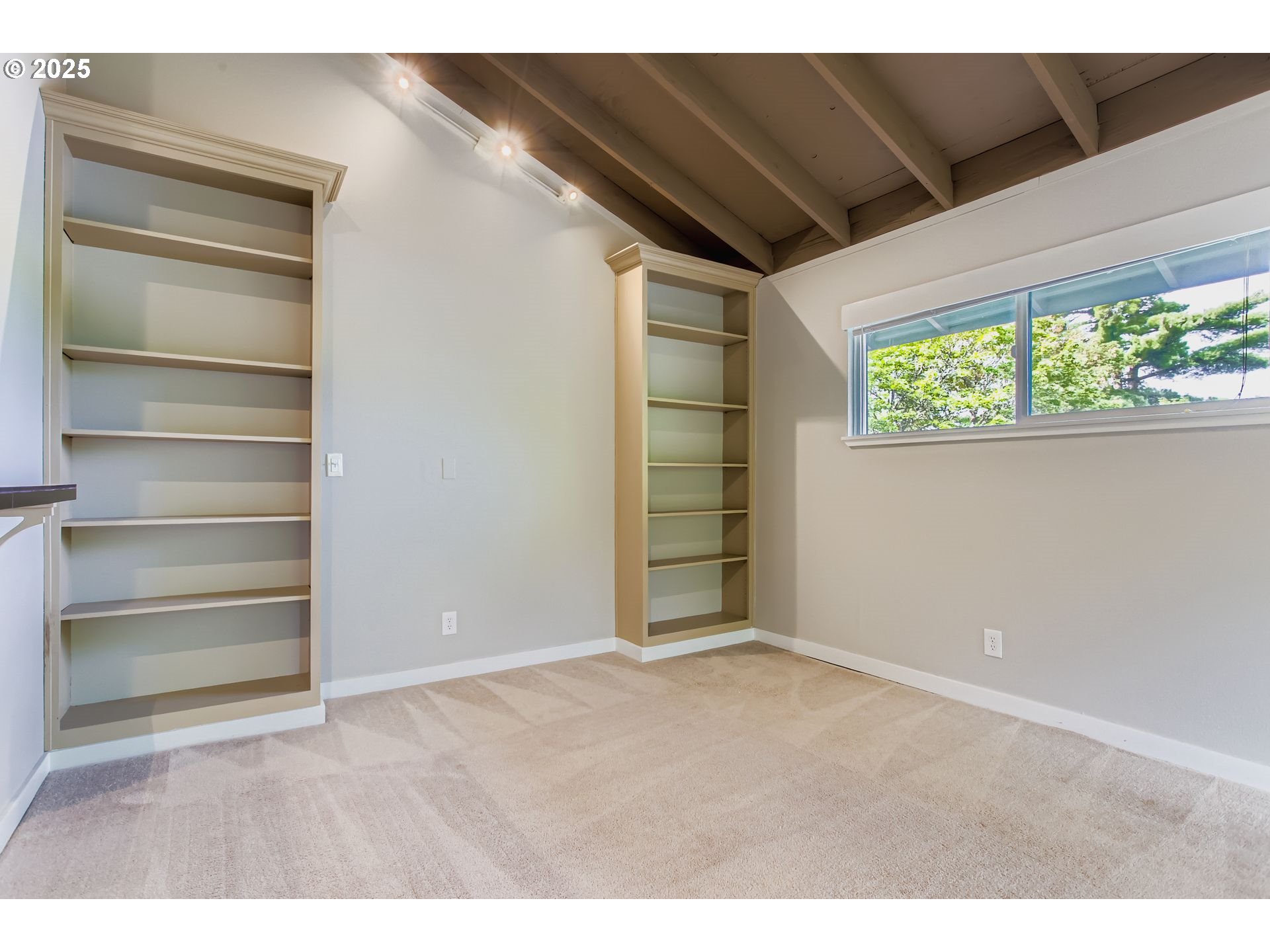 7514 Southwest Barnes Road, Unit A Portland, OR 97225 - Photo 7 of 24 a view of an empty room with a window