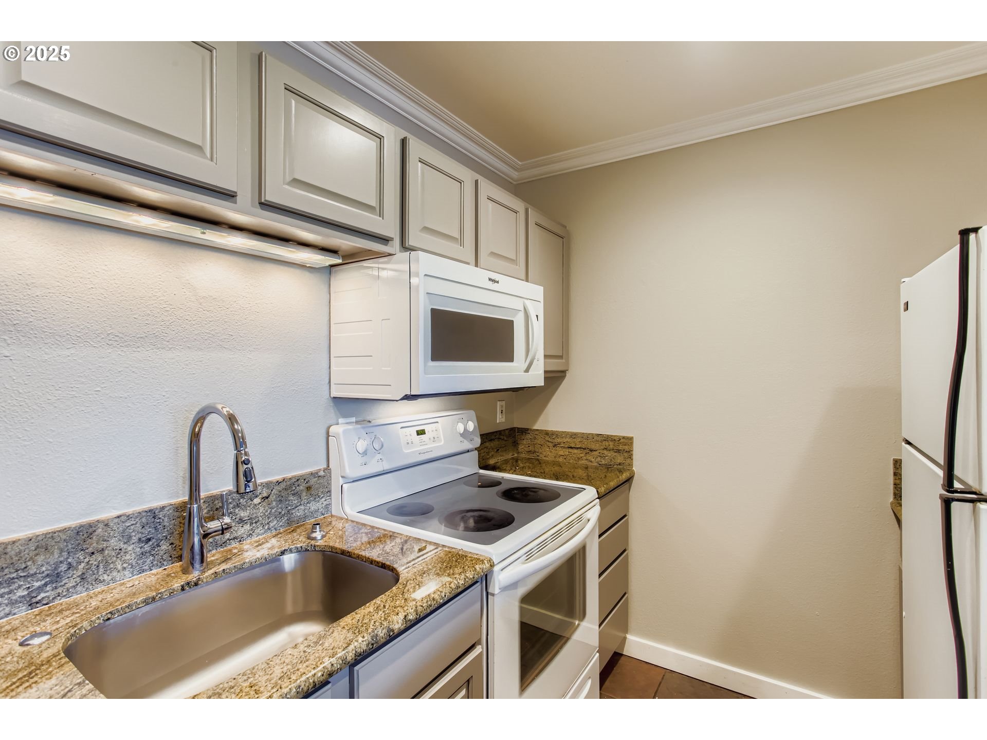 7514 Southwest Barnes Road, Unit A Portland, OR 97225 - Photo 10 of 24 a kitchen with stainless steel appliances a sink a stove and a refrigerator with wooden cabinets
