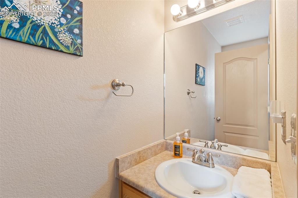 4005 Siferd Boulevard Colorado Springs, CO 80917 - Photo 15 of 27 a bathroom with a sink and a mirror