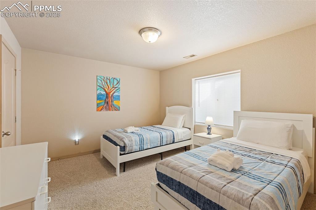 4005 Siferd Boulevard Colorado Springs, CO 80917 - Photo 21 of 27 a bedroom with two beds and painting on the wall