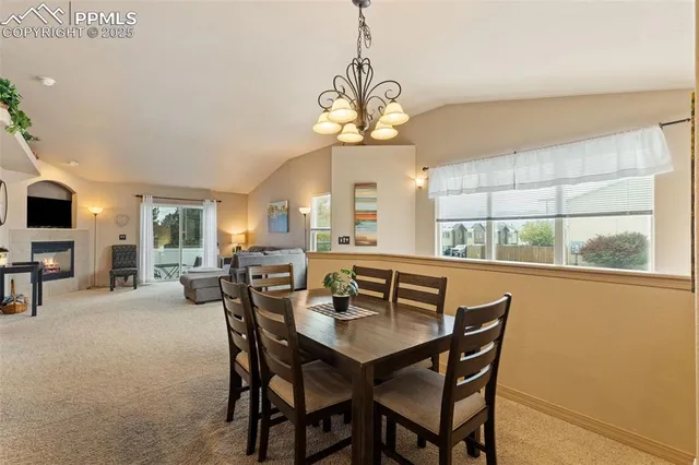 a view of a dining room with furniture window and outside view