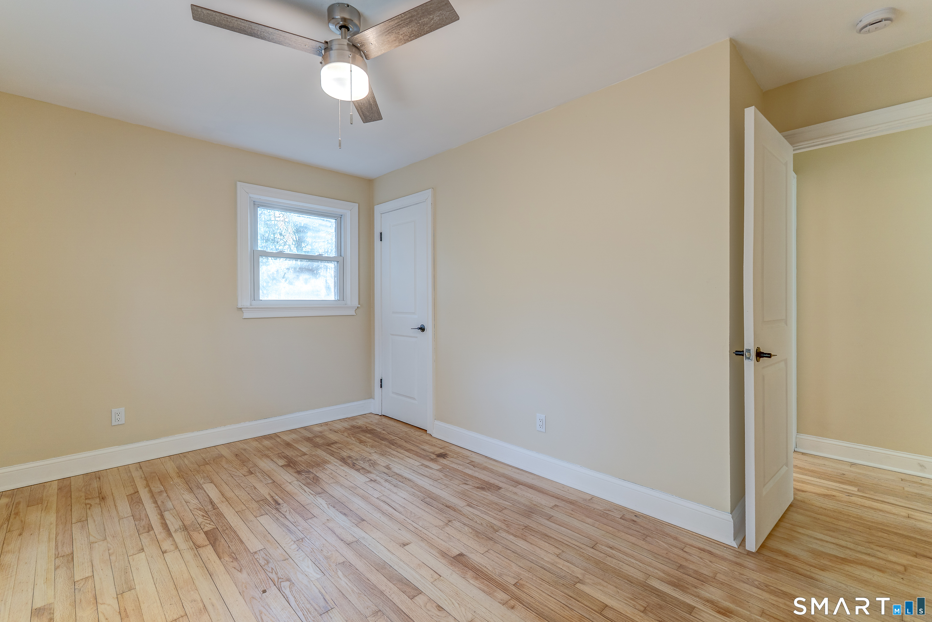 24 Evergreen Road North Branford, CT 06472 - Photo 17 of 24 a view of empty room with wooden floor and fan