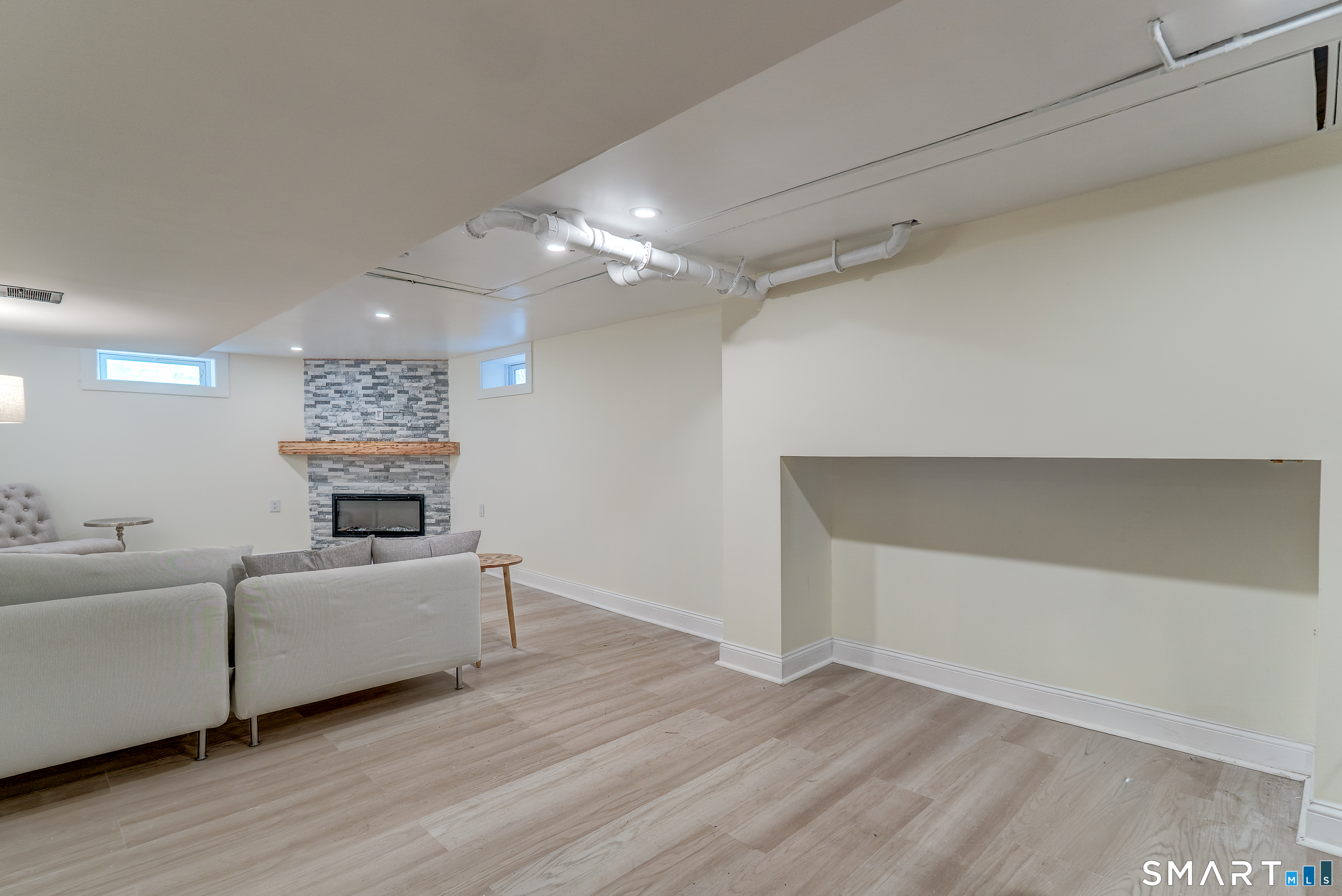 24 Evergreen Road North Branford, CT 06472 - Photo 20 of 24 a living room with furniture and a chandelier