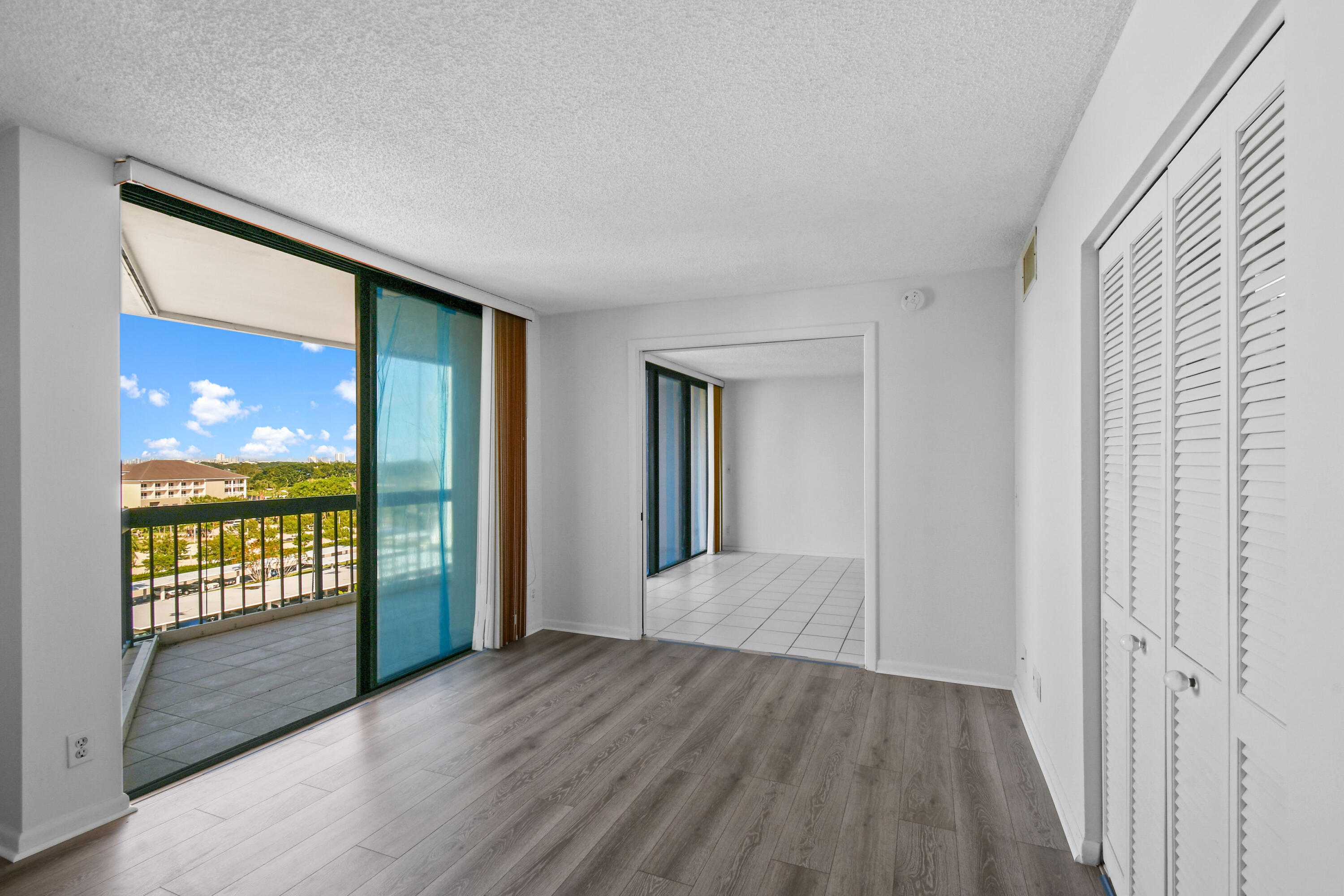 2425 Presidential Way, Unit 801 West Palm Beach, FL 33401 - Photo 11 of 41 wooden floor in an empty room with a window